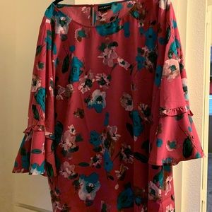 Pink floral blouse with ruffle sleeves.